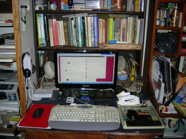 A cluttered writing desk.